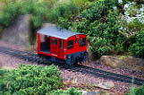 Little model railroad car on tracks